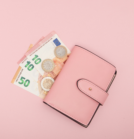 Wallet with Euro Currency on a Vibrant Blue Background.の写真素材