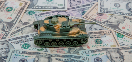 tank against the background of dollars. Concept of war.の写真素材