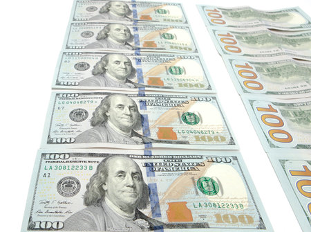 Large surface covered with US cash notes.High angle view of US hundred cash notes carefully spread...
