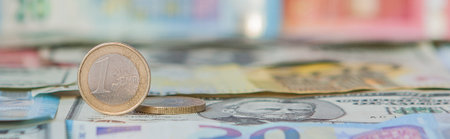 Financial dominance: One Euro in a vice against the background of the American Dollar and Euro with...