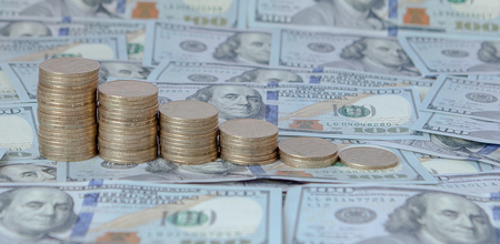 Financial concept image. Histogram of coins against the background of dollars.の写真素材