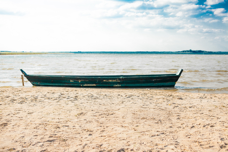 Old fisherman boat at sunrise time on the beach.の写真素材