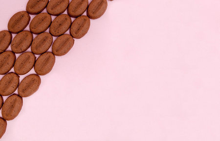 Cookies in the form of coffee on a pink background with copy space.の写真素材