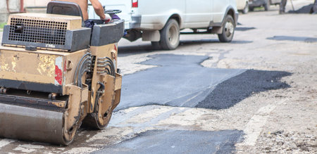 Road roller makes the paving.Close view on the road roller working on the road construction site.