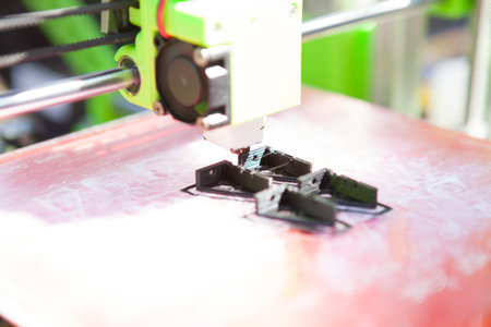 A desktop 3d printer in the laboratory for prints a structure from a polymer.