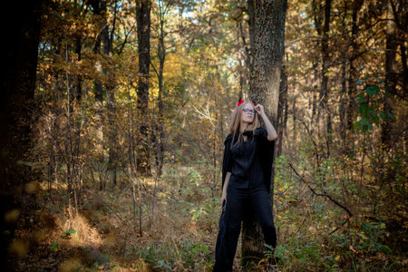 Teenager in Halloween costumes in the woods