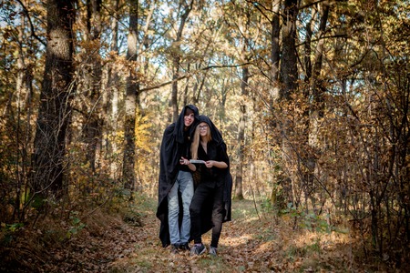 Teenagers in Halloween costumes in the woods.の写真素材
