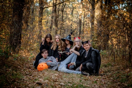 Teenagers in Halloween costumes in the woods.の写真素材