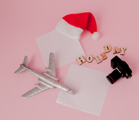 Inscription travel , Camera, Airplane and money on a pink background. Travel concept.の写真素材