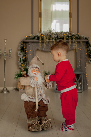 Boy is welcome with santa. Holidays, present, childhood happiness conceptの写真素材