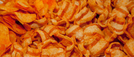 background corrugated golden chips with texture. A variety of potato chips background. Background...