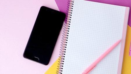 Creative flat lay photo of workspace desk with smartphone,and notebook with copy space background, minimal style.の写真素材