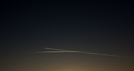 Airplane in the sky at sunset. The plane is in the sky at sunsetの写真素材