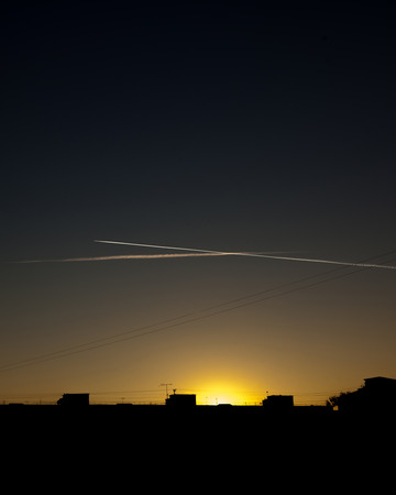Airplane in the sky at sunset. The plane is in the sky at sunset.の写真素材