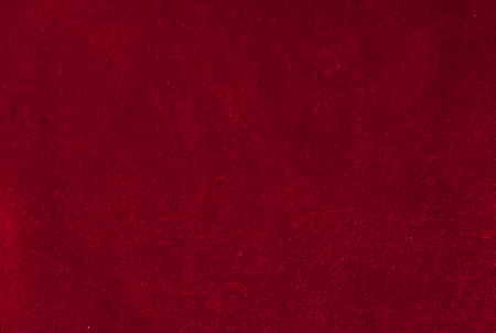 Close up of red velvet paper with embossed flowers.の写真素材