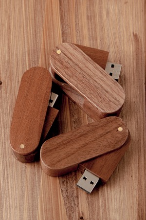 wooden usb flash drive on wooden desk.の写真素材