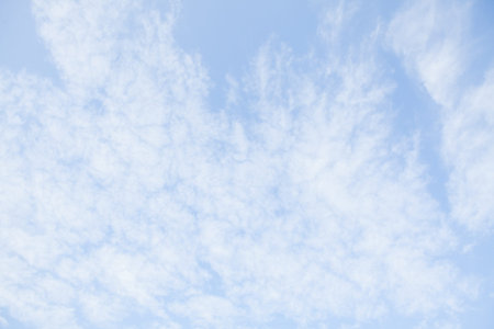 Blue sky with white clouds. Beautiful sky background. Clear day and good weather.