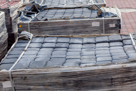 New paving slab on pallets, building materials for the reconstruction of the pavement. Selective focus, close-up.の写真素材