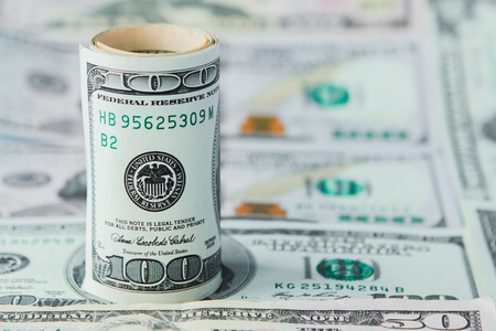 Close-up of stack of dollars against the backdrop of money.の写真素材