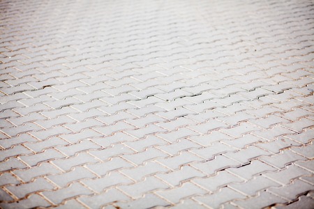 Stone pavement texture. Granite cobblestoned pavement background. Abstract background of old cobblestone pavement close-up. Seamless texture. Perfect tiled on all sides.の写真素材