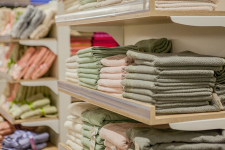 Stack of colorful towels in the department store. Many pile of cotton towels in store shop. Concept of shopping, buy and sell.の写真素材