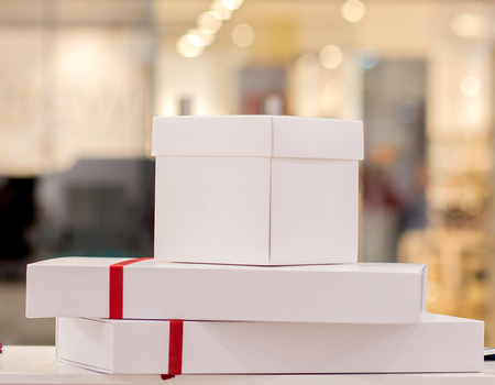 Various colorful cute gift boxes on display in store. Birthday, Christmas, Valentine day gifts. Getting ready for holidays, sale concept.の写真素材