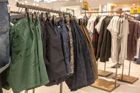 Shorts on the store shelf. Fashionable clothes on the shelves in the store. Shorts hanging on the...