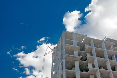High-rise multi-storey buildings under construction. Tower cranes near building. Activity,...