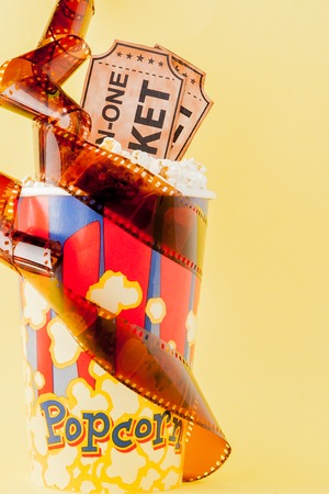 Movie tickets, film strips and popcorn on blue background. Copy space for text.の写真素材