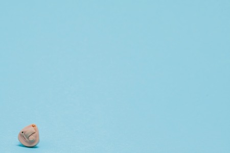 Hearing aid on blue background. Medical, pharmacy and healthcare concept. Copy space. Empty place for textの写真素材