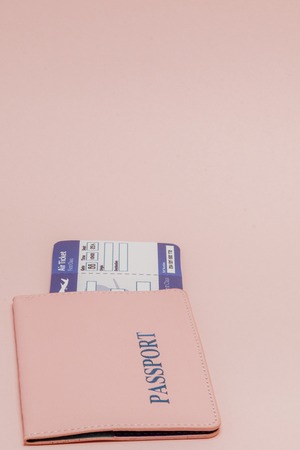 Passport and air ticket on a pink background. Travel concept, copy space.の写真素材