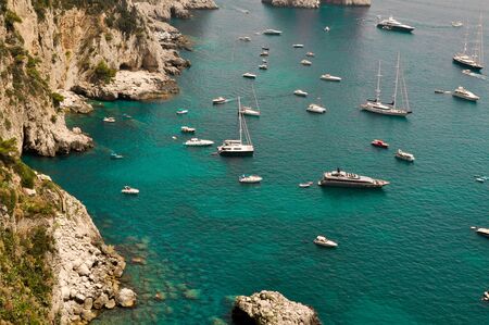 Many boats on waters of sea, boats moored in the small harbor.の写真素材