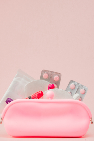 Women intimate hygiene products - sanitary pads and tampons on pink background, copy space. Menstrual period concept. Top view, flat lay, copy space.の写真素材