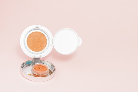 Make up products spilling on pink background with copy space, minimal styleの写真素材