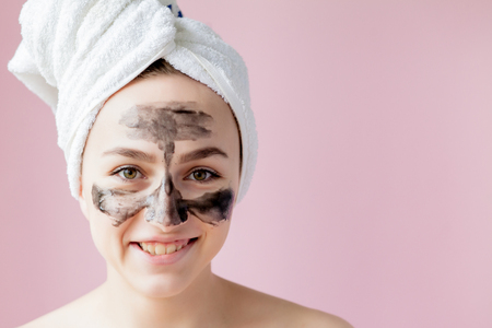 Beauty Cosmetic Peeling. Closeup Beautiful Young Female With Black Peel Off Mask On Skin. Closeup Of Attractive Woman With Cosmetic Skin Care Peeling Product On Face. High Resolution.の写真素材