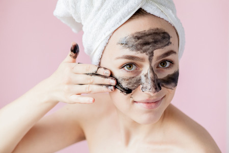 Beauty Cosmetic Peeling. Closeup Beautiful Young Female With Black Peel Off Mask On Skin. Closeup Of Attractive Woman With Cosmetic Skin Care Peeling Product On Face. High Resolution.の写真素材