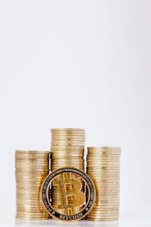Histograma of coins and bitcoin on the white background. Concept of currency growth, savings.