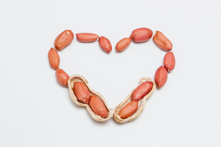 Peanuts, for background or textures. Uncleaned inshell peanuts. Peanuts isolated on white...