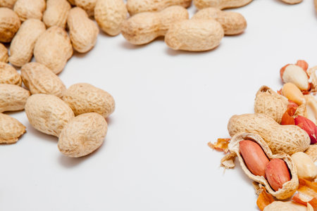 Large peeled peanuts close-up of beans in the shell. Unpeeled peanuts in the shell. Peanuts, for...