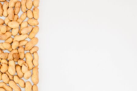 Large peeled peanuts close-up of beans in the shell. Unpeeled peanuts in the shell. Peanuts, for background or texture. Growing organic protein.の写真素材