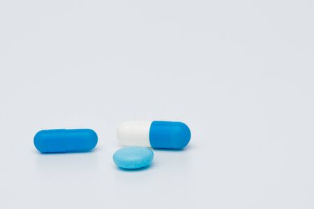 Macro view of capsule pill and tablet isolated over white background.の写真素材
