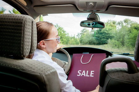 Woman with her shopping bags into the car - shopping conceptの写真素材