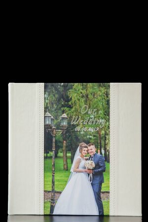 Kyiv, Ukraine- May 15, 2019 Pages of wedding photobook or wedding album on black background.のeditorial素材