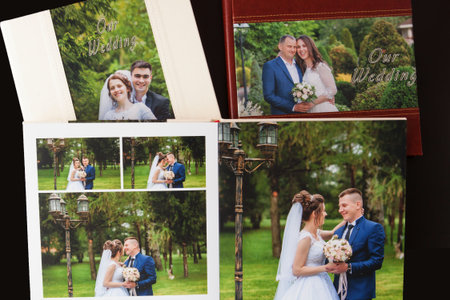 Kyiv, Ukraine- May 15, 2019 Pages of wedding photobook or wedding album on black background.