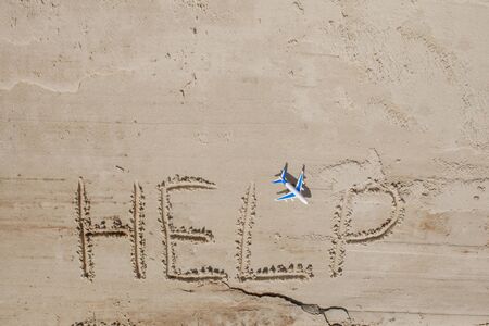 Help me the inscription and plane on the sand. Please help me. On a tropical beach.の写真素材