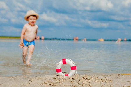 Close-up Of Lifebuoy on the beach on baby background. Safety on the waterの写真素材