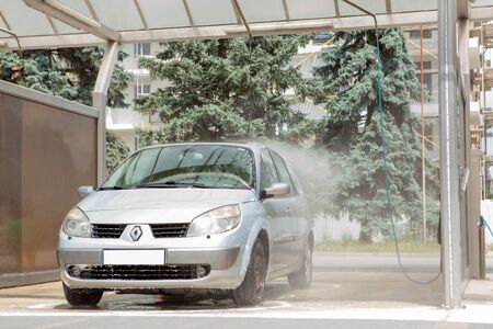 Kyiv, Ukraine- May 15, 2019 Manual car wash with pressurized water in car wash outside.のeditorial素材