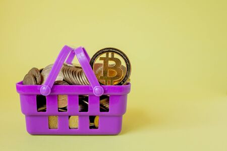 Cryptocurrency digital payment concept, various of silver and golden physical digital crypto money coins in shopping basket.の写真素材