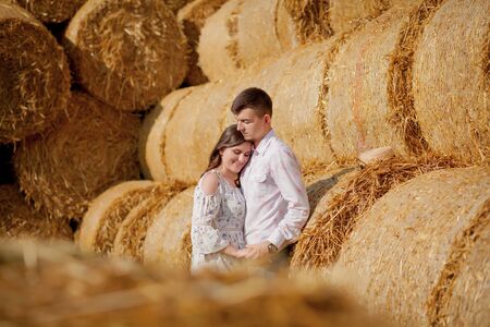 Happy young couple on straw, romantic people concept, beautiful landscape, summer season.の写真素材