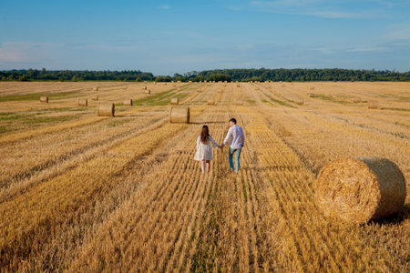 Happy young couple on straw, romantic people concept, beautiful landscape, summer season.